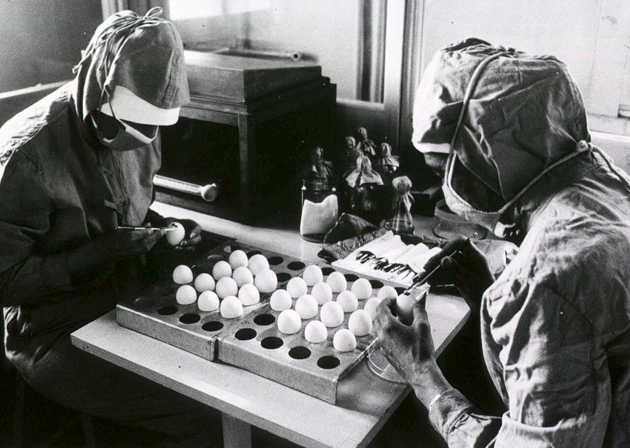 Health workers preparing measles vaccine doses (illustrative; not tied to a specific patient or facility)