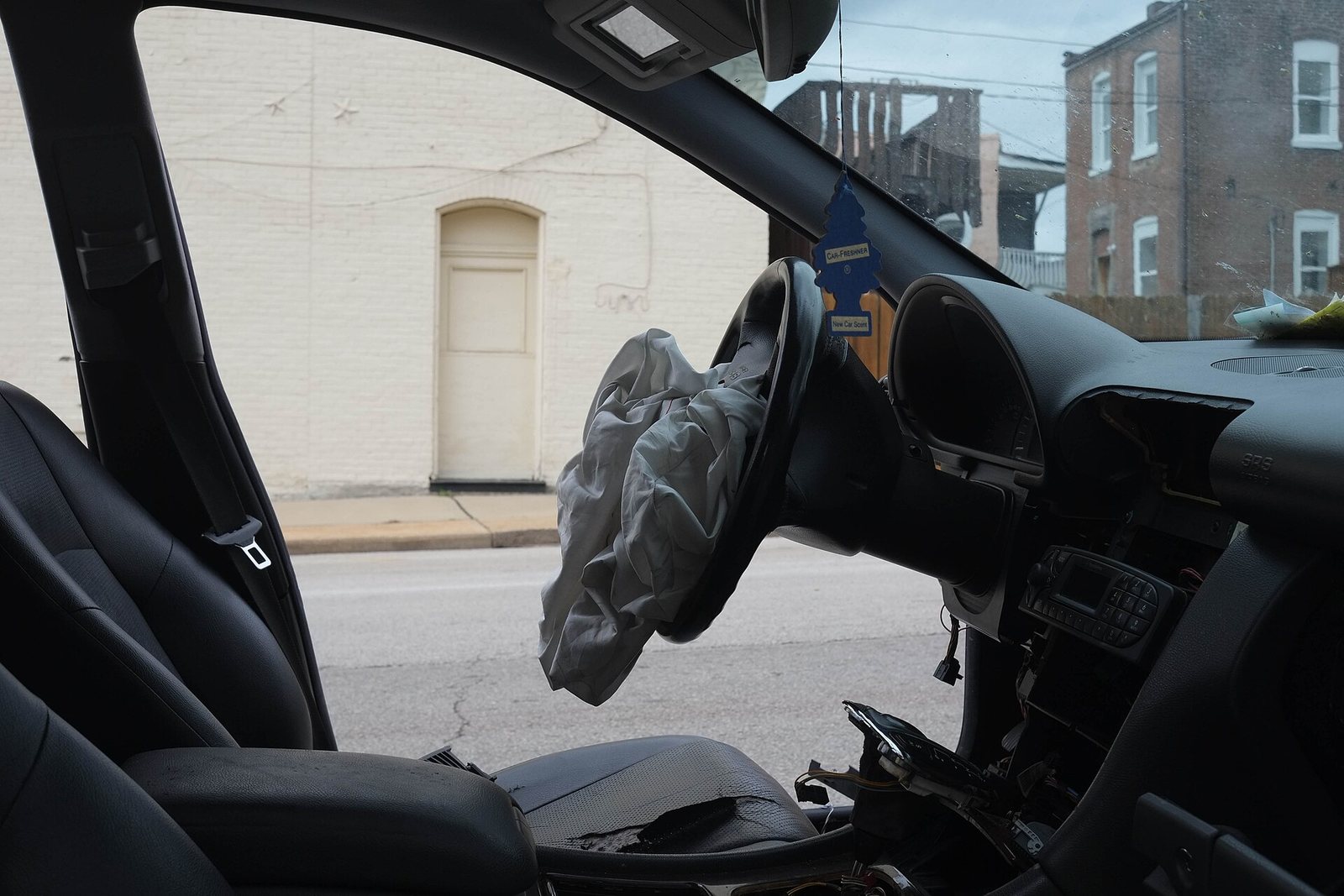 A deployed steering-wheel airbag inside a damaged car — illustrative, not a product listed on eBay