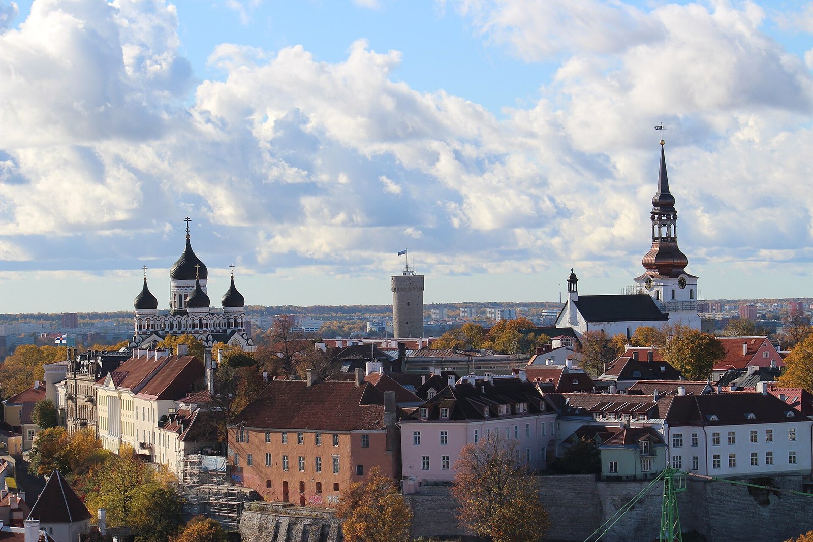 Illustrative image of the Tallinn skyline in autumn, with the Old Town’s rooftops, church spires and an onion-domed cathedral under a partly cloudy sky