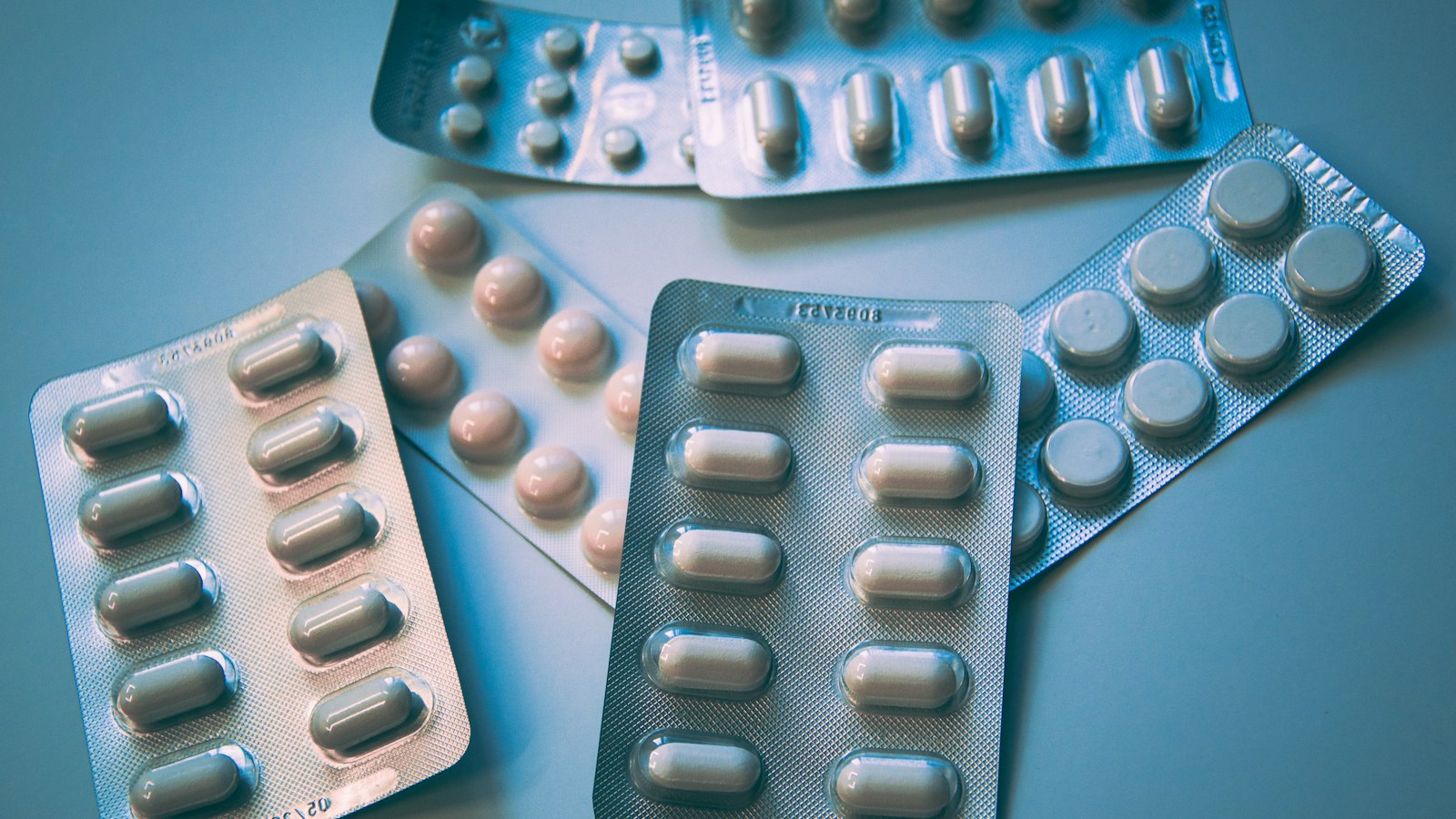 Illustrative medication bottles and pills — diabetes treatment theme, not a patient photo