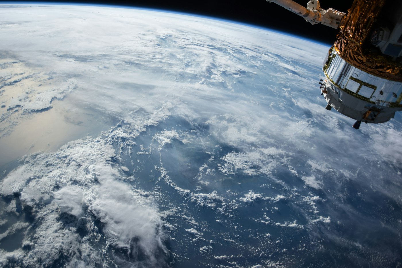 Earth from orbit with starfield — space exploration theme