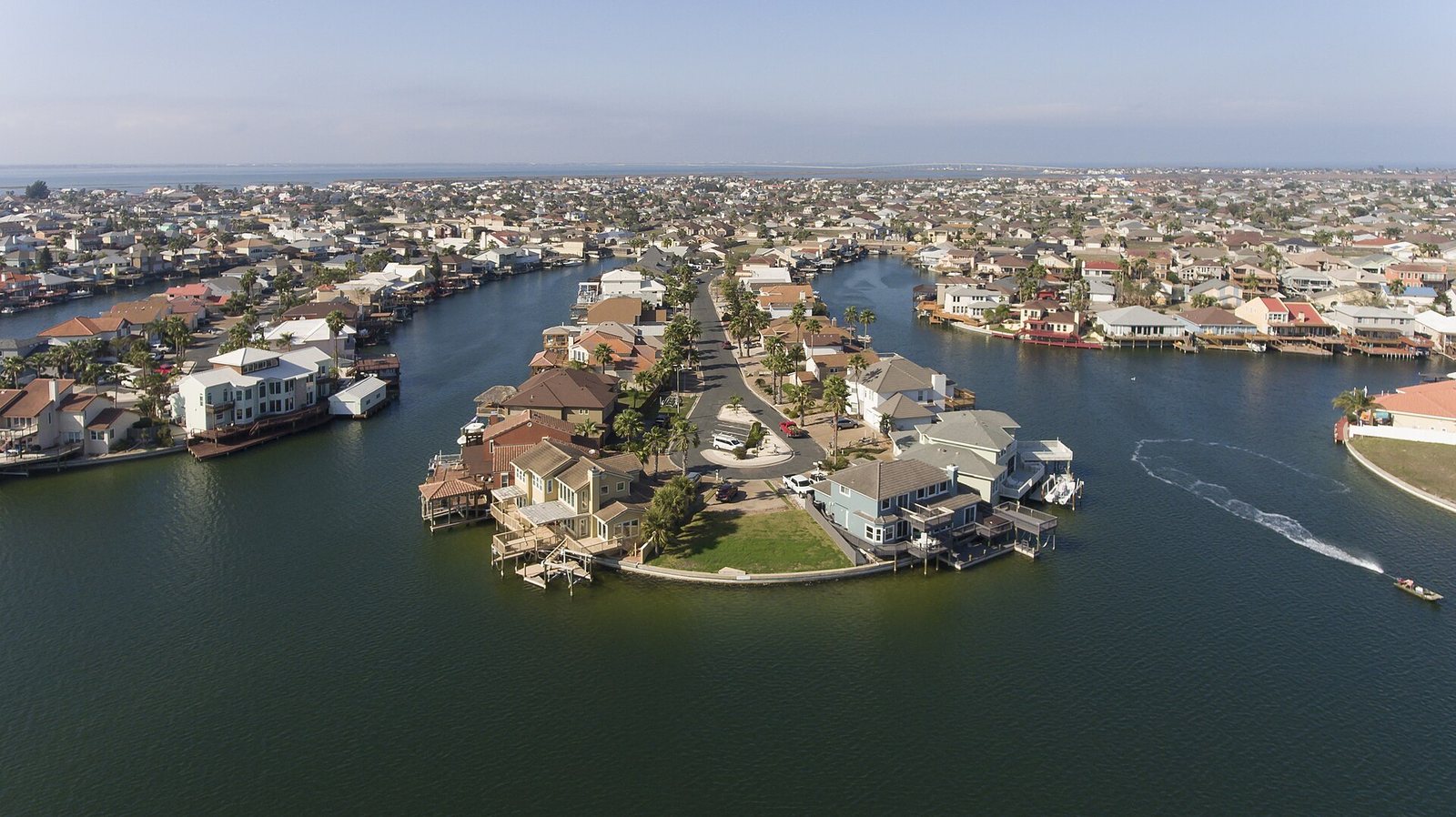 Aerial view of a waterfront residential neighborhood on Padre Island, Texas — illustrative, not a specific listed property