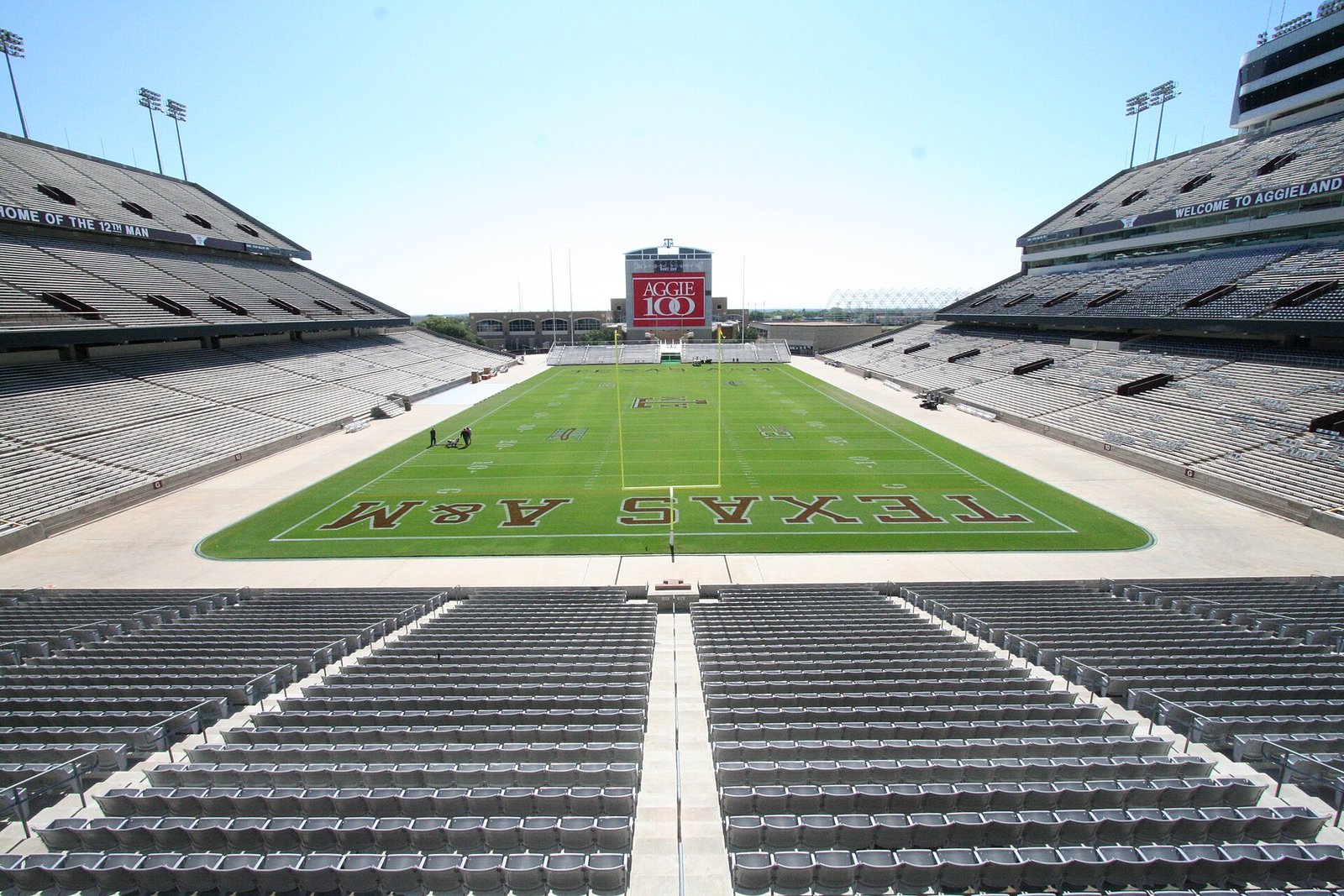 Illustrative image of an empty college football stadium, Kyle Field at Texas A&M, with rows of vacant seats facing a green field